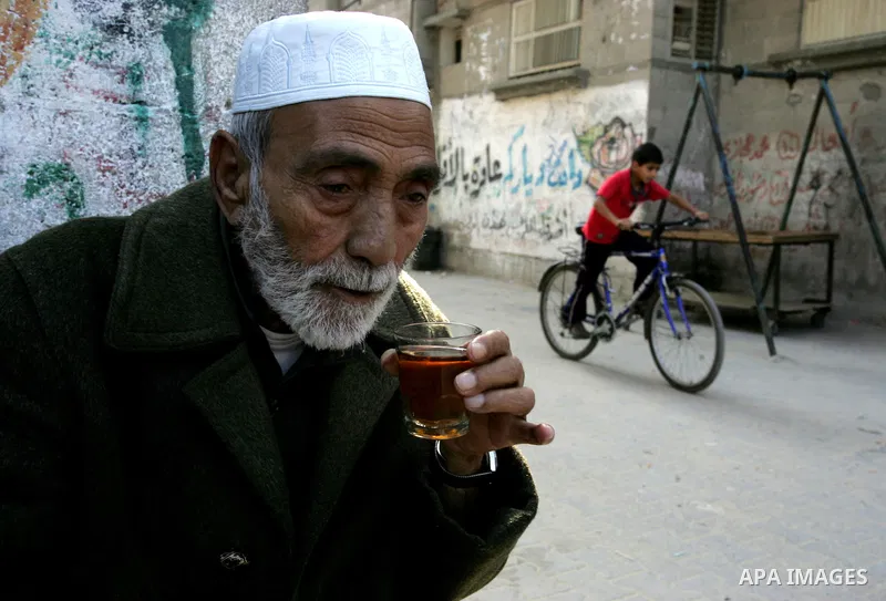 Palestinian man sit outside their house in Rafah refugee camp in the southern Gaza Strip on Nov. 12, 2011. According to a member of the Executive Committee of the Palestine Liberation Organisation Saeb Erekat, there is n...