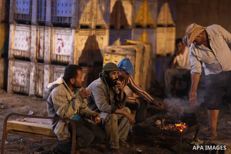 Palestinian men take a break at an olive oil press in Gaza City, in the Gaza Strip on November 12, 2011. photo by Wissam Nassar