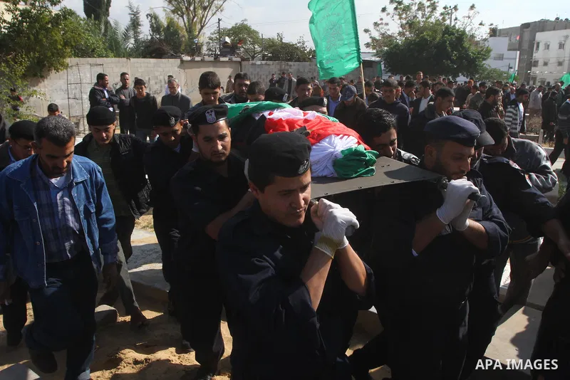 Palestinian police officers carry the body of Mohammed Al Kelani, a Hamas security officer, during his funeral in Beit Lahiya, northern Gaza Strip, Monday, Nov. 14, 2011. Al Kelani was killed in an Israeli air strike on...