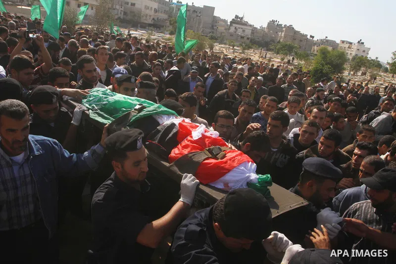Palestinian police officers carry the body of Mohammed Al Kelani, a Hamas security officer, during his funeral in Beit Lahiya, northern Gaza Strip, Monday, Nov. 14, 2011. Al Kelani was killed in an Israeli air strike on...