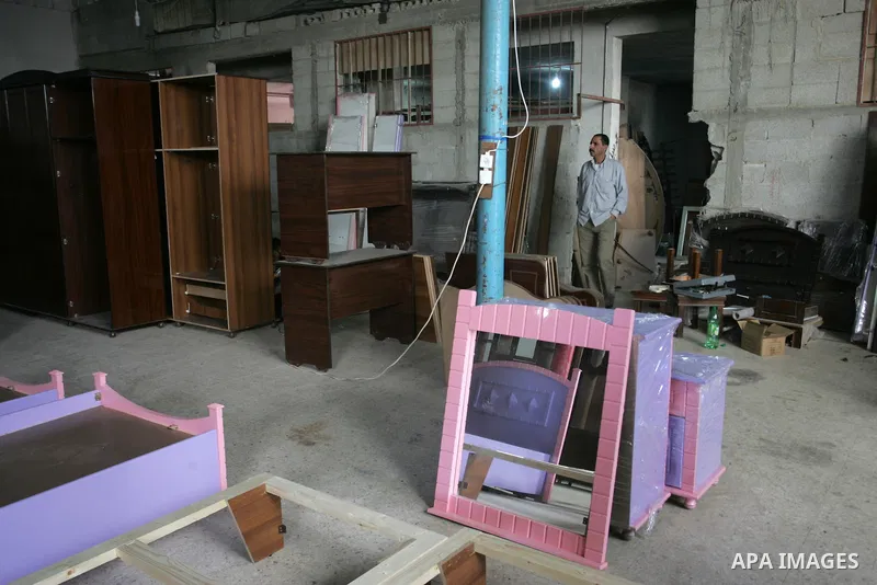 A Palestinian carpenter works at his workshop for woodwork in Rafah, southern Gaza Strip on November 14, 2011. An official in the General Federation of Palestinian Industries in Gaza Strip said on Sunday that the Israeli...