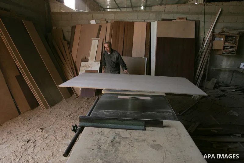 A Palestinian carpenter works at his workshop for woodwork in Rafah, southern Gaza Strip on November 14, 2011. An official in the General Federation of Palestinian Industries in Gaza Strip said on Sunday that the Israeli...