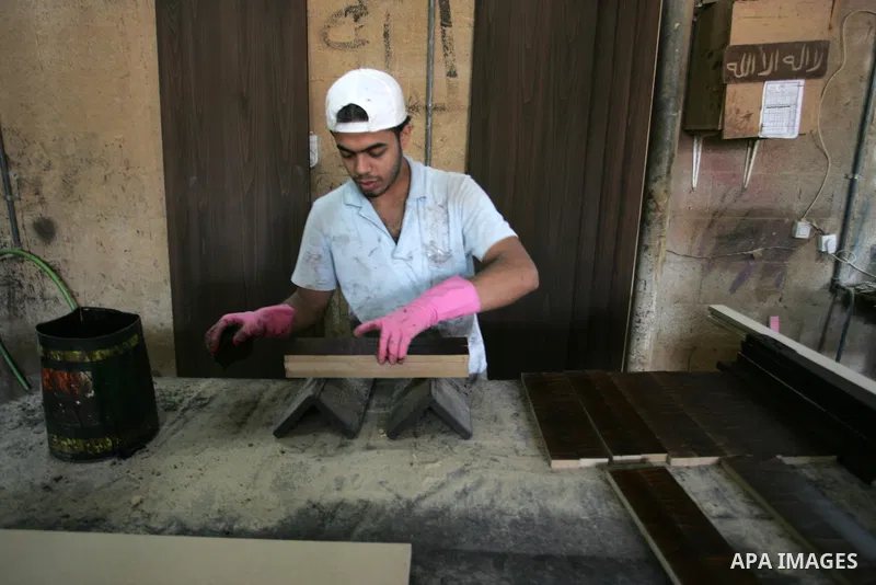 A Palestinian carpenter works at his workshop for woodwork in Rafah, southern Gaza Strip on November 14, 2011. An official in the General Federation of Palestinian Industries in Gaza Strip said on Sunday that the Israeli...