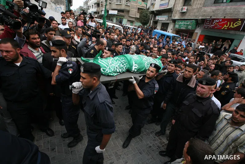 Palestinian police officers carry the body of Mohammed Al Kelani, a Hamas security officer, during his funeral in Beit Lahiya, northern Gaza Strip, Monday, Nov. 14, 2011. Al Kelani was killed in an Israeli air strike on...