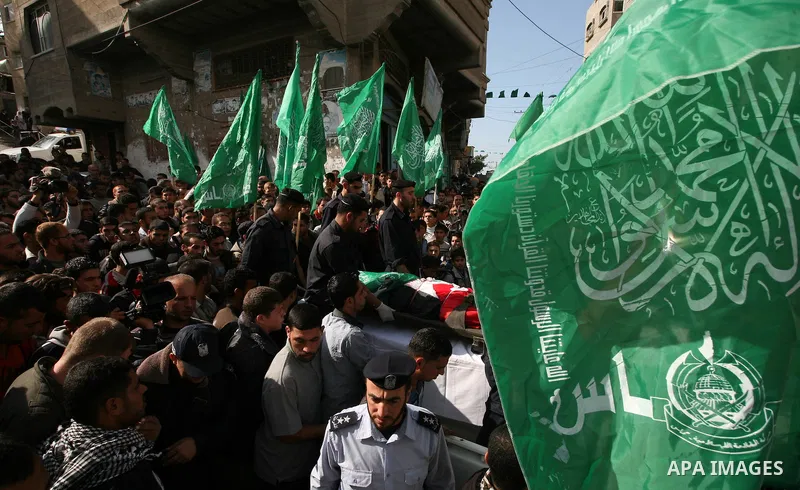 Palestinian police officers carry the body of Mohammed Al Kelani, a Hamas security officer, during his funeral in Beit Lahiya, northern Gaza Strip, Monday, Nov. 14, 2011. Al Kelani was killed in an Israeli air strike on...