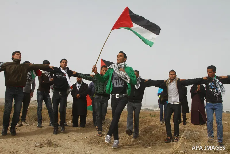 Palestinian protesters wave national flags during a demonstration on Tuesday Nov. 15, 2011 on the outskirts of Gaza City to mark the 23rd anniversary of the Palestinian Independence Day. Palestinians have marked Nov. 15...