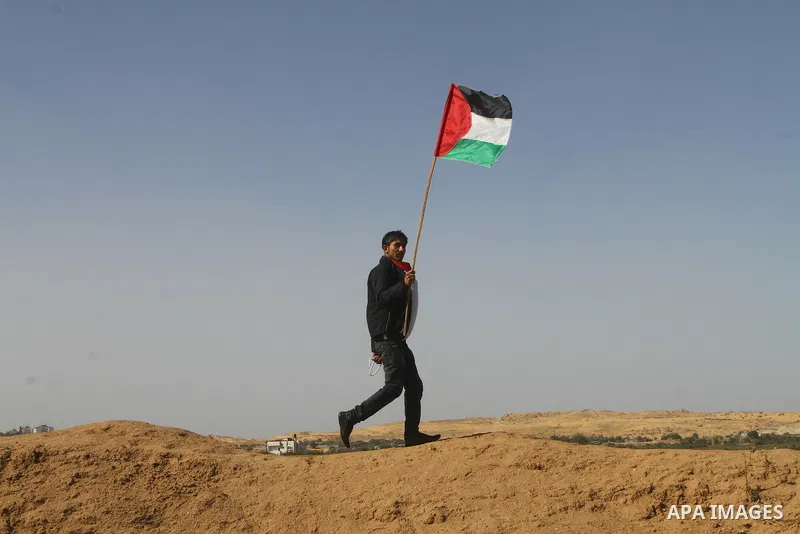 Palestinian protesters wave national flags during a demonstration on Tuesday Nov. 15, 2011 on the outskirts of Gaza City to mark the 23rd anniversary of the Palestinian Independence Day. Palestinians have marked Nov. 15...