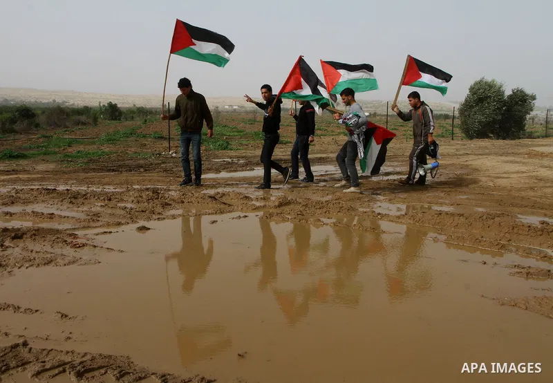 Palestinian protesters wave national flags during a demonstration on Tuesday Nov. 15, 2011 on the outskirts of Gaza City to mark the 23rd anniversary of the Palestinian Independence Day. Palestinians have marked Nov. 15...