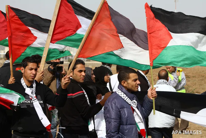 Palestinian protesters wave national flags during a demonstration on Tuesday Nov. 15, 2011 on the outskirts of Gaza City to mark the 23rd anniversary of the Palestinian Independence Day. Palestinians have marked Nov. 15...