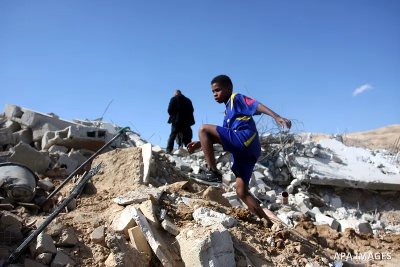 Palestinians check belongings scattered on the ground after Israeli bulldozers razed four Palestinian homes near the ancient city of Jericho on November 15, 2011 with Israel saying they endangered a nearby archaeological...