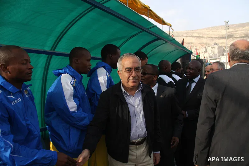 Palestinian Prime Minister, Salam Fayyad attends the football match between Palestine national team and South Africa team in the West Bank city of Nablus on Nov. 15, 2011. Photo by Wagdi Eshtayah