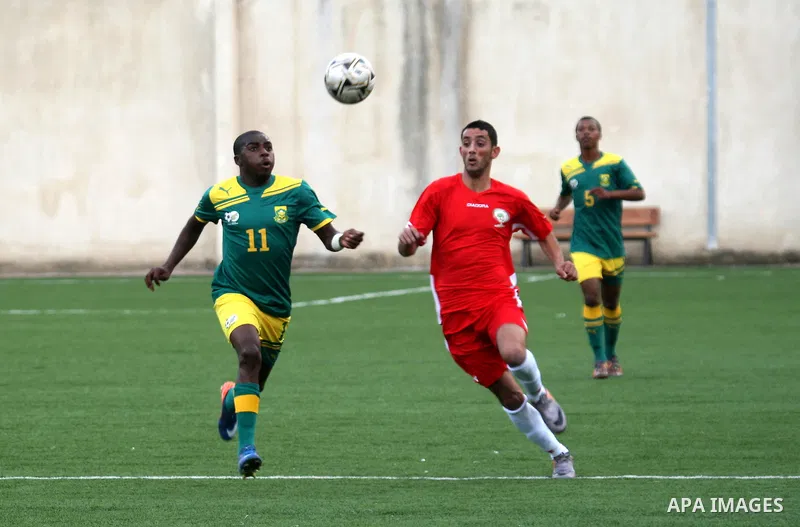 South African (Green) and Palestinian (Red) football players fight for the ball during football match in the West Bank town of Nablus, on Nov. 15, 2011. The match ended in 1-1draw. Photo by Wagdi Eshtayah