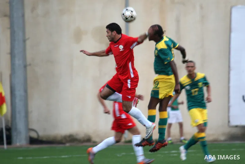 South African (Green) and Palestinian (Red) football players fight for the ball during football match in the West Bank town of Nablus, on Nov. 15, 2011. The match ended in 1-1draw. Photo by Wagdi Eshtayah