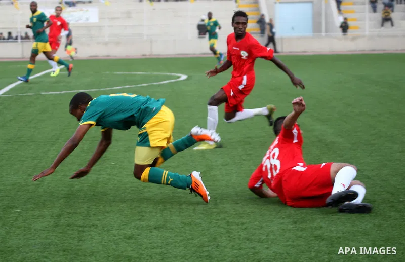 South African (Green) and Palestinian (Red) football players fight for the ball during football match in the West Bank town of Nablus, on Nov. 15, 2011. The match ended in 1-1draw. Photo by Wagdi Eshtayah