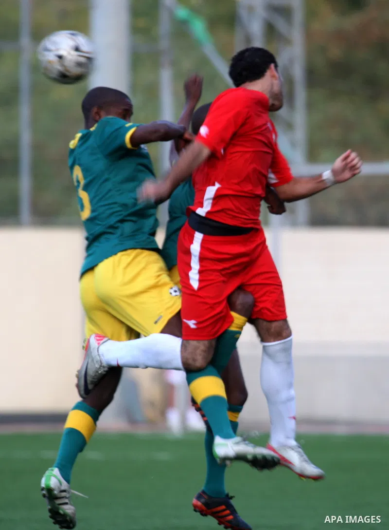 South African (Green) and Palestinian (Red) football players fight for the ball during football match in the West Bank town of Nablus, on Nov. 15, 2011. The match ended in 1-1draw. Photo by Wagdi Eshtayah