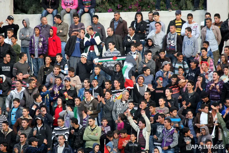Palestinian fans attend a match between South Africa football team and Palestine team in the West Bank town of Nablus, on Nov. 15, 2011. The match ended in 1-1draw. Photo by Wagdi Eshtayah