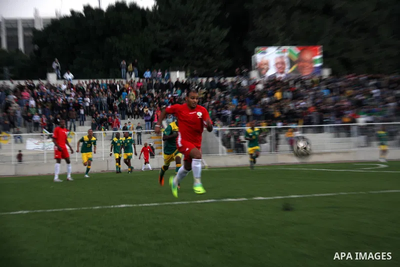 South African (Green) and Palestinian (Red) football players fight for the ball during football match in the West Bank town of Nablus, on Nov. 15, 2011. The match ended in 1-1draw. Photo by Wagdi Eshtayah