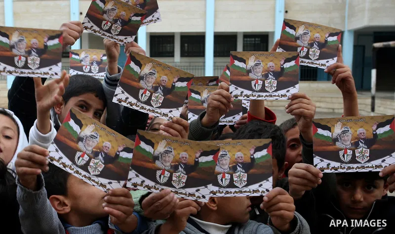 A Palestinian children holds posters of Palestinian President Mahmoud Abbas during a rally in the West Bank city of Nablus on Nov. 16, 2011 . Photo by Wagdi Eshtayah