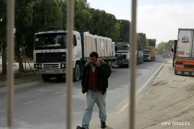 Palestinians check trucks loaded with construction materials at the Rafah crossing which entered through Israel's Kerem Shalom crossing in southern Gaza Strip on November 16, 2011. Israel allowed to enter the constructio...