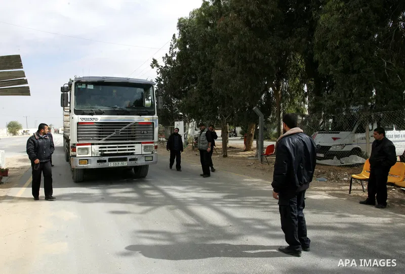 Palestinians check trucks loaded with construction materials at the Rafah crossing which entered through Israel's Kerem Shalom crossing in southern Gaza Strip on November 16, 2011. Israel allowed to enter the constructio...