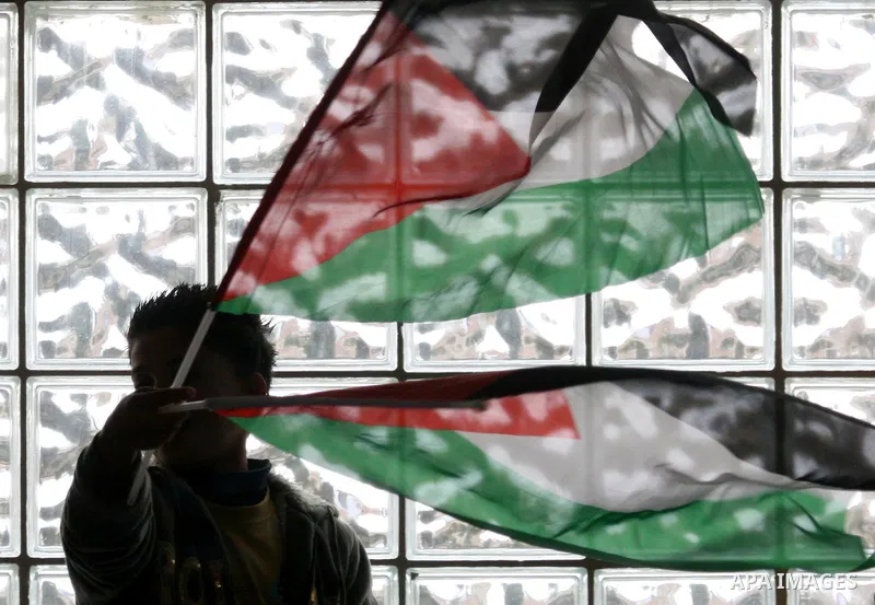 Supporters of the Palestinian President Mahmoud Abbas gather during his speech to the Palestinian leadership on November 16, 2011 in the West Bank city of Ramallah. The address was timed to mark seven years since the dea...