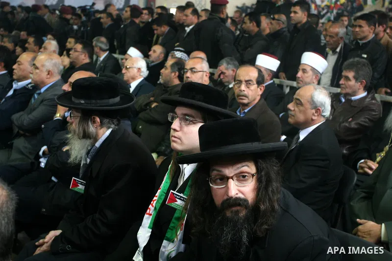 Members of Neturei Karta, a small faction of Ultra-Orthodox Jews who oppose Israel's existence, sit amidst the public during a speech by Palestinian leader Mahmud Abbas to the Palestinian leadership on November 16, 2011...