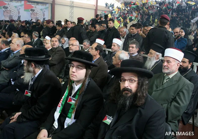 Members of Neturei Karta, a small faction of Ultra-Orthodox Jews who oppose Israel's existence, sit amidst the public during a speech by Palestinian leader Mahmud Abbas to the Palestinian leadership on November 16, 2011...