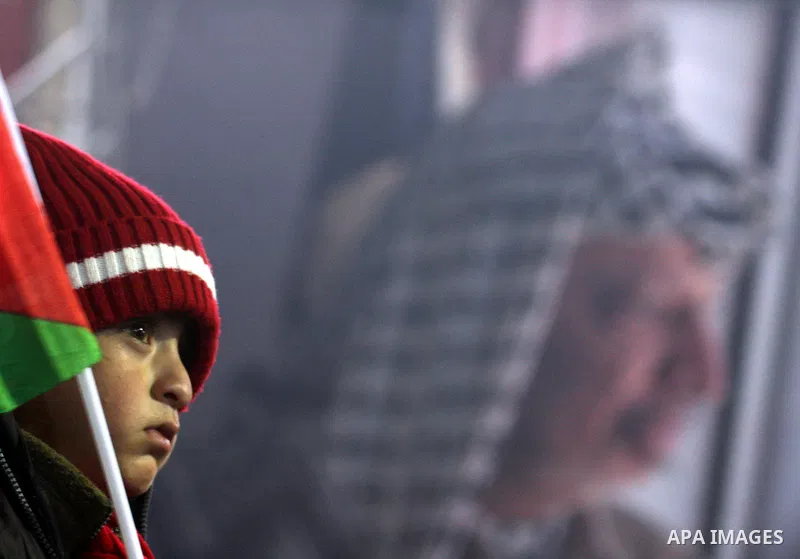 Supporters of the Palestinian President Mahmoud Abbas gather during his speech to the Palestinian leadership on November 16, 2011 in the West Bank city of Ramallah. The address was timed to mark seven years since the dea...