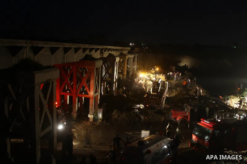 Palestinian rescue teams inspect the scene of a collapsed bridge on a main road in the central Gaza Strip that links Gaza City with the south, near Nusseirat, on November 17, 2011. Medical sources said two Palestinian wo...