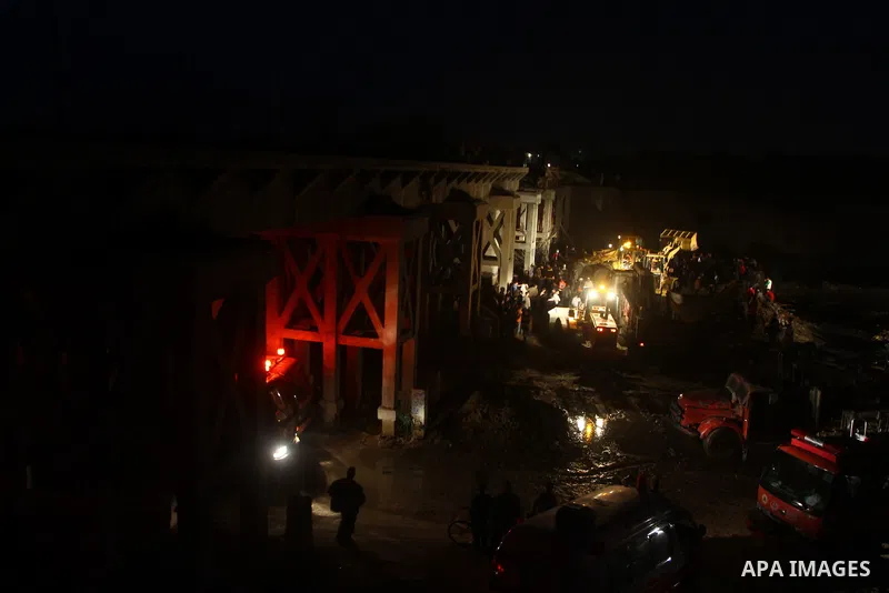 Palestinian rescue teams inspect the scene of a collapsed bridge on a main road in the central Gaza Strip that links Gaza City with the south, near Nusseirat, on November 17, 2011. Medical sources said two Palestinian wo...