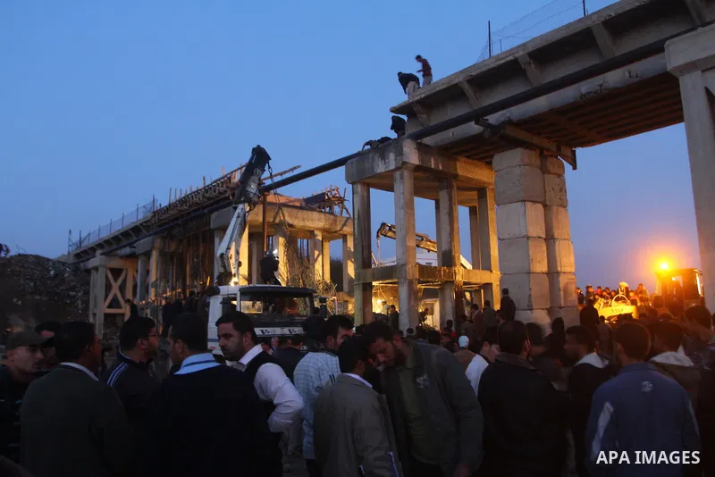 Palestinian rescue teams inspect the scene of a collapsed bridge on a main road in the central Gaza Strip that links Gaza City with the south, near Nusseirat, on November 17, 2011. Medical sources said two Palestinian wo...