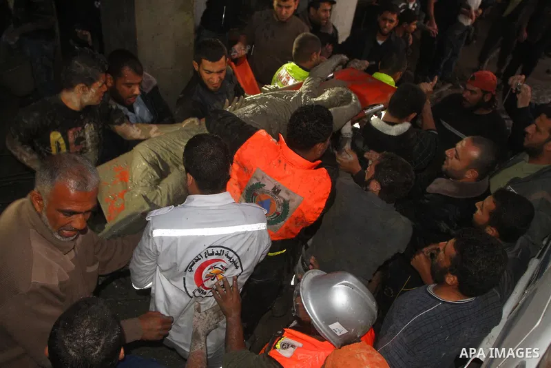 Palestinian rescue teams inspect the scene of a collapsed bridge on a main road in the central Gaza Strip that links Gaza City with the south, near Nusseirat, on November 17, 2011. Medical sources said two Palestinian wo...