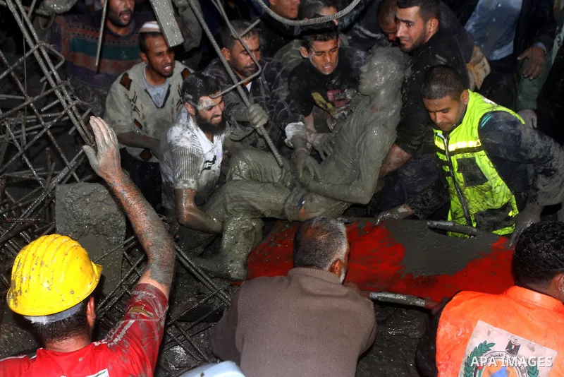 Palestinian rescue teams inspect the scene of a collapsed bridge on a main road in the central Gaza Strip that links Gaza City with the south, near Nusseirat, on November 17, 2011. Medical sources said two Palestinian wo...