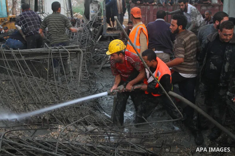 Palestinian rescue teams inspect the scene of a collapsed bridge on a main road in the central Gaza Strip that links Gaza City with the south, near Nusseirat, on November 17, 2011. Medical sources said two Palestinian wo...