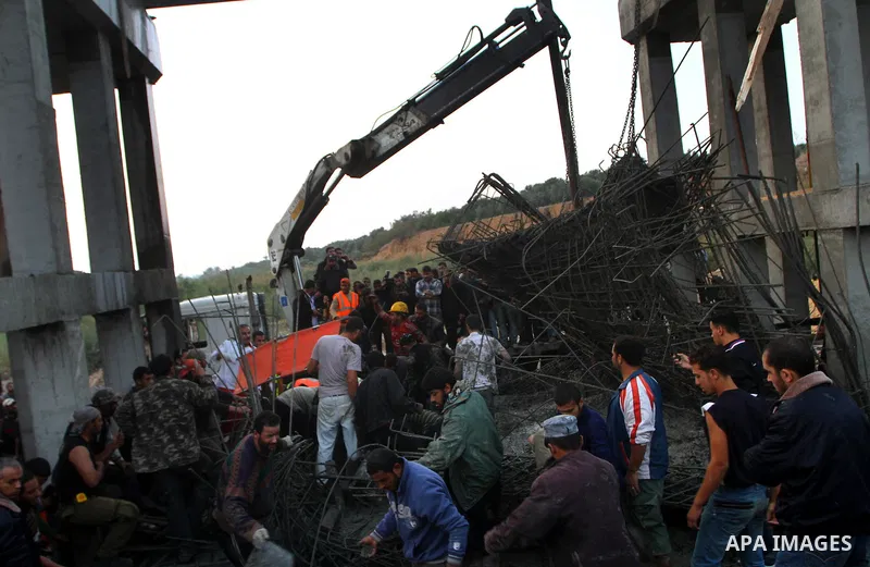 Palestinian rescue teams inspect the scene of a collapsed bridge on a main road in the central Gaza Strip that links Gaza City with the south, near Nusseirat, on November 17, 2011. Medical sources said two Palestinian wo...