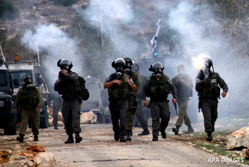 Israeli border police officers fire tear gas toward Palestinian demonstrators, who are seeking access to their land near Kufr Qaddum, near the northern West Bank Jewish settlement of Kdumim, Friday, Nov. 18, 2011. Photo...