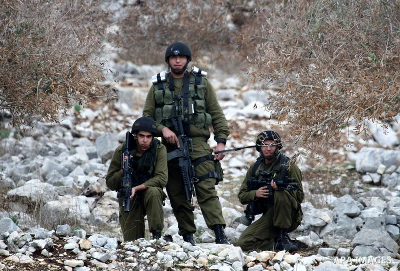 Israeli border police officers fire tear gas toward Palestinian demonstrators, who are seeking access to their land near Kufr Qaddum, near the northern West Bank Jewish settlement of Kdumim, Friday, Nov. 18, 2011. Photo...