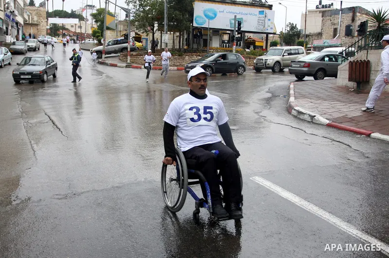 Palestinians participate in a marathon entitled " Charity for them" in the West Bank city of Ramallah November 18, 2011. Photo by Issam Rimawi