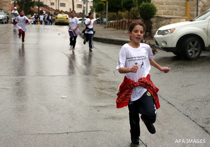 Palestinians participate in a marathon entitled " Charity for them" in the West Bank city of Ramallah November 18, 2011. Photo by Issam Rimawi