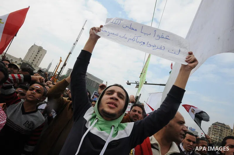 Protesters chant slogans in Tahrir Square, the focal point of the uprising that ousted President Hosni Mubarak, in Cairo, Egypt, Friday, Nov. 18, 2011. Thousands of Egyptians are rallying in Cairo's Tahrir square, with I...
