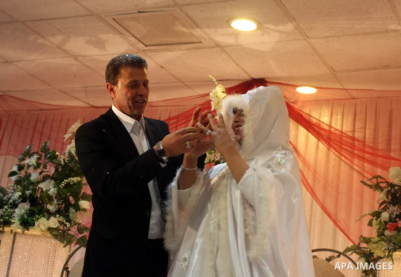 Palestinian freed prisoner Nael Barghouti and his bride Amal Nafea are greeted by relatives and friends during their wedding, in the West Bank city of Ramallah on Nov. 18,2011. Nael Barghouti released from the Israeli ja...