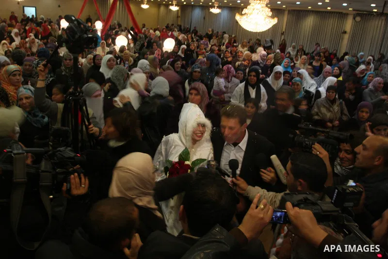 Palestinian freed prisoner Nael Barghouti and his bride Amal Nafea are greeted by relatives and friends during their wedding, in the West Bank city of Ramallah on Nov. 18,2011. Nael Barghouti released from the Israeli ja...