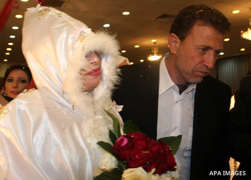 Palestinian freed prisoner Nael Barghouti and his bride Amal Nafea are greeted by relatives and friends during their wedding, in the West Bank city of Ramallah on Nov. 18,2011. Nael Barghouti released from the Israeli ja...