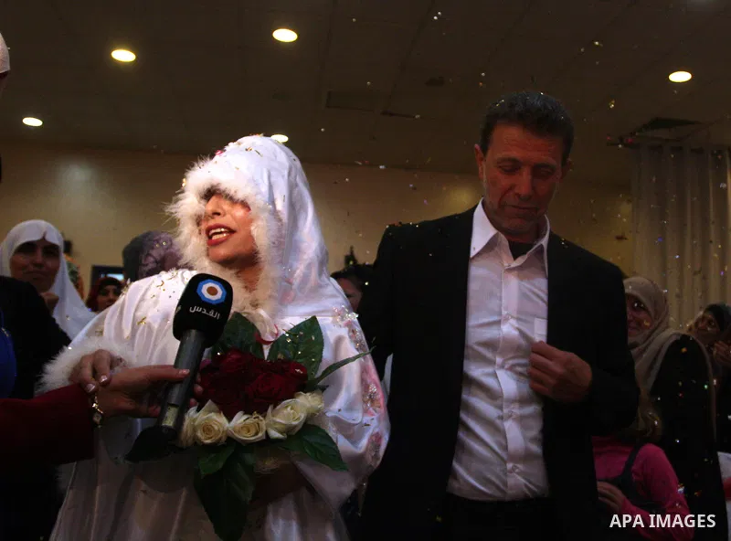 Palestinian freed prisoner Nael Barghouti and his bride Amal Nafea are greeted by relatives and friends during their wedding, in the West Bank city of Ramallah on Nov. 18,2011. Nael Barghouti released from the Israeli ja...