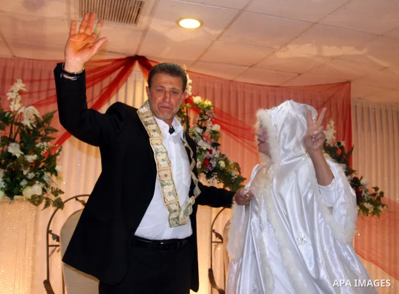 Palestinian freed prisoner Nael Barghouti and his bride Amal Nafea are greeted by relatives and friends during their wedding, in the West Bank city of Ramallah on Nov. 18,2011. Nael Barghouti released from the Israeli ja...
