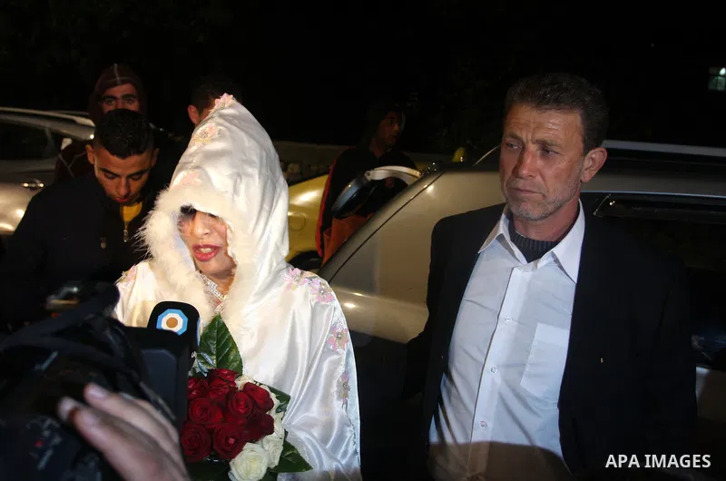 Palestinian freed prisoner Nael Barghouti and his bride Amal Nafea are greeted by relatives and friends during their wedding, in the West Bank city of Ramallah on Nov. 18,2011. Nael Barghouti released from the Israeli ja...