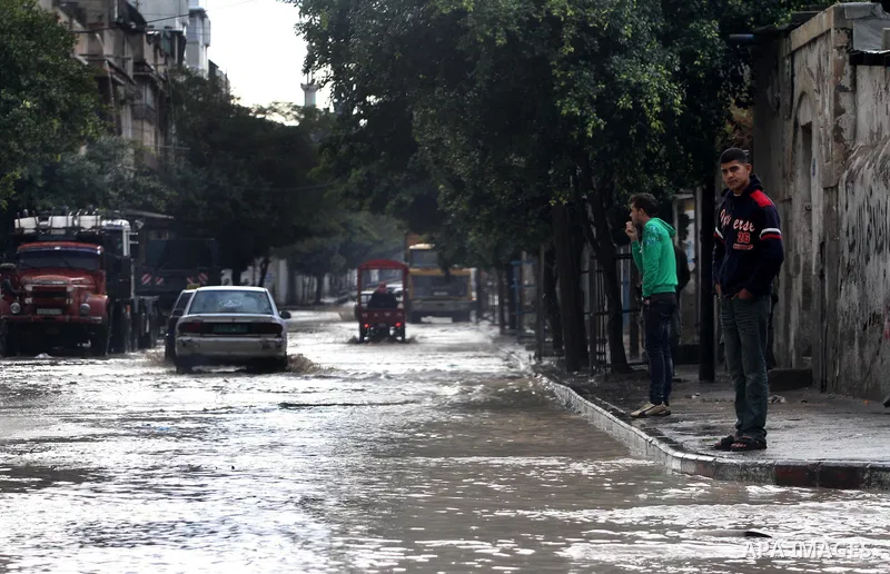 Palestinians walks through a flooded street after heavy rain and cold winds in Gaza City, On Nov. 19, 2011. Photo by Mohammed Asad