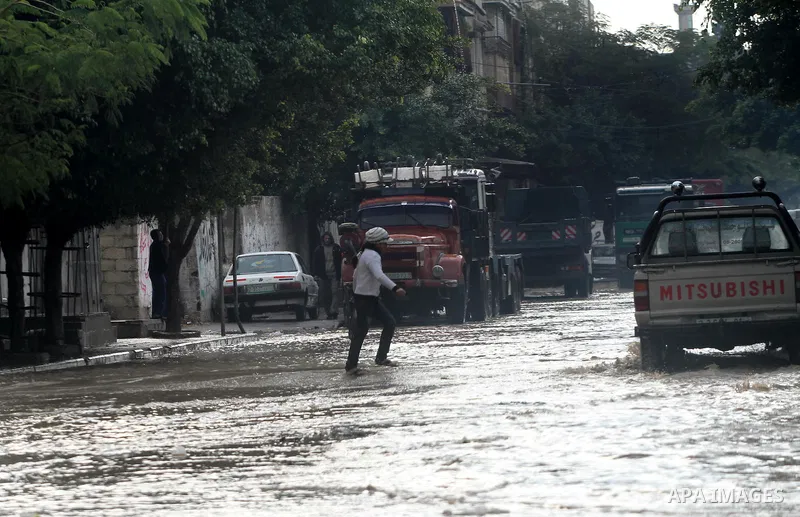 Palestinians walks through a flooded street after heavy rain and cold winds in Gaza City, On Nov. 19, 2011. Photo by Mohammed Asad