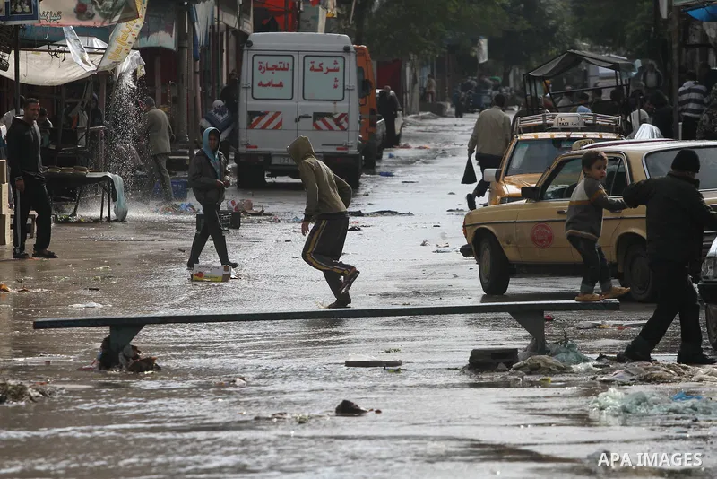 Palestinians walks through a flooded street after heavy rain and cold winds in Gaza City, On Nov. 19, 2011. Photo by Mohammed Asad