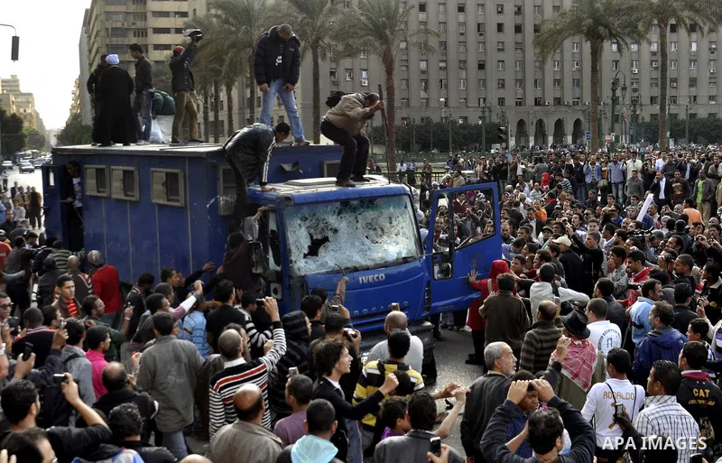 Protesters throw stones at Egyptian riot police during clashes in Tahrir Square in Cairo, Egypt, Saturday, Nov. 19, 2011. Thousands of police clashed with protesters for control of downtown Cairo's Tahrir Square on Satur...